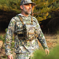 Man in Forloh full camouflage hunting outfit with tactical gear in a forest setting