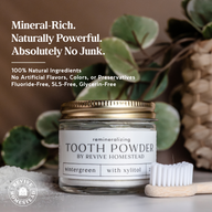Showcases Revive Homestead's remineralizing tooth powder with wintergreen and xylitol flavor next to a bamboo toothbrush.
