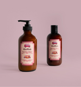 Two bottles of VanMan's Sweet Onion Shampoo sit against a soft pink background.
