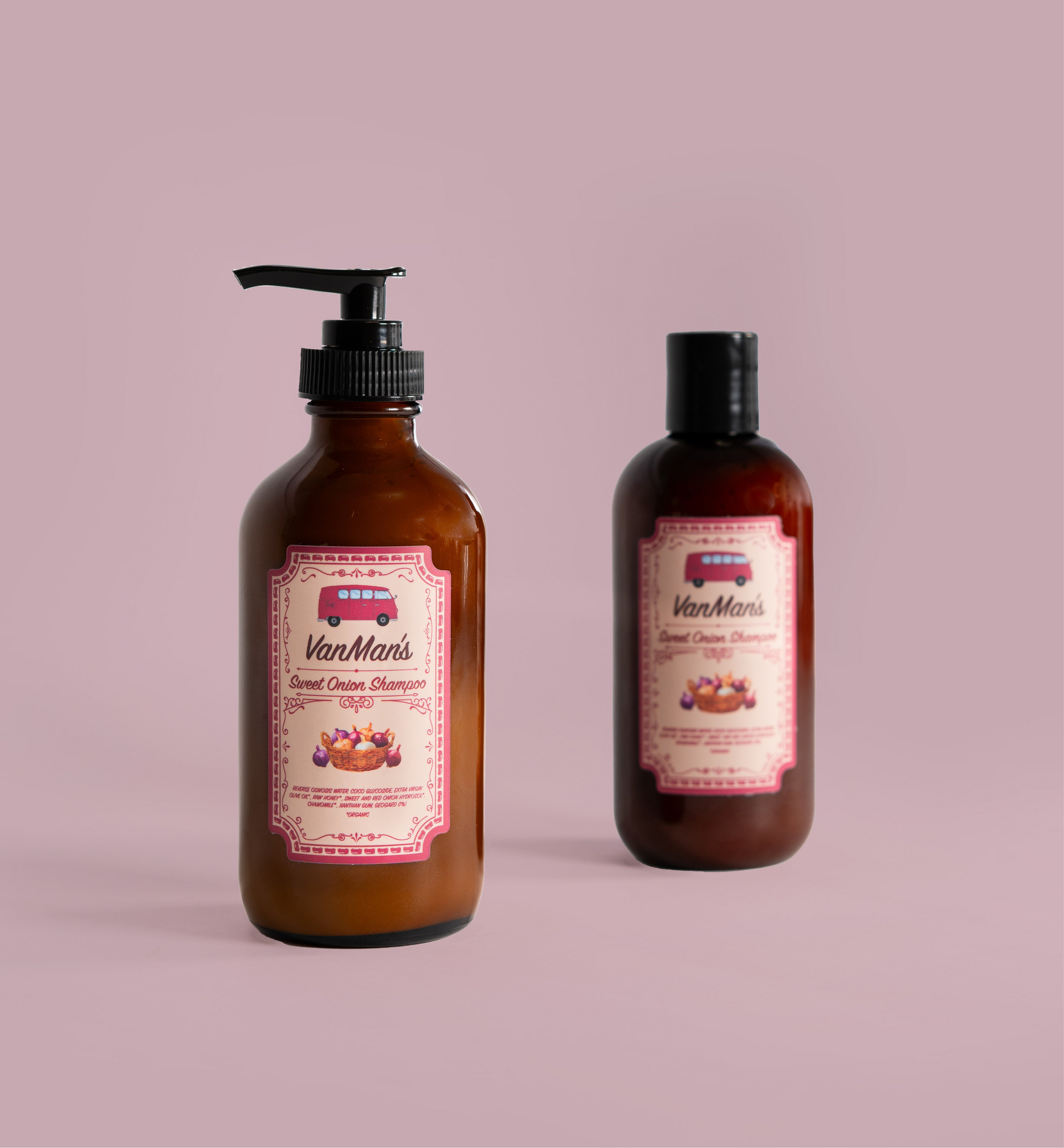 Two bottles of VanMan's Sweet Onion Shampoo sit against a soft pink background.
