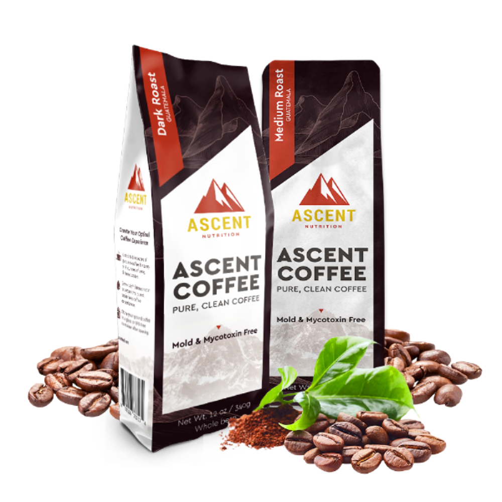 Two Ascent Coffee packages with coffee beans and leaves on a white background