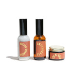 Three URB Apothecary skincare products, including Willow Cleanser, Sweetgrass spray, and Pot of Gold cream, sit on a white surface.
