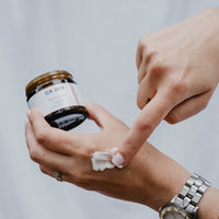 Woman rubbing lotion onto hand