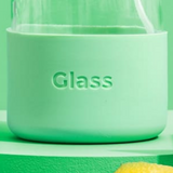 Glass bottle features "Glass" embossed design on its mint green silicone sleeve.
