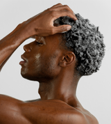 man washing his hair with shampoo