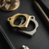 Two thumper tools, one gold and one silver, on a dark surface.