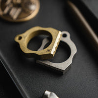 Two thumper tools, one gold and one silver, on a dark surface.