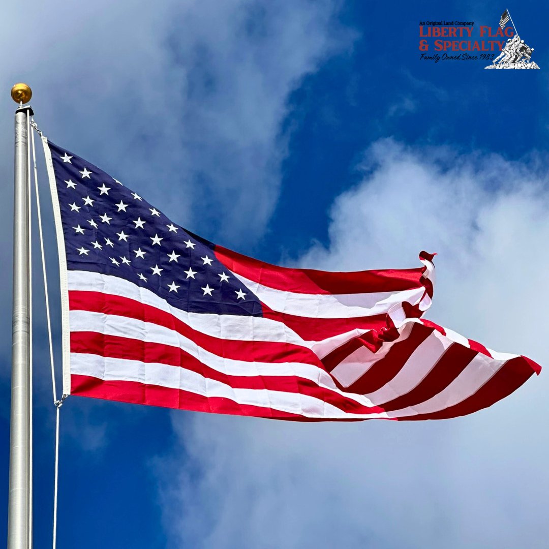 American flag waving against a blue sky with a visible brand logo.