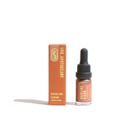 Urb. Apothecary presents their bronzing serum in a small dropper bottle next to its orange packaging.
