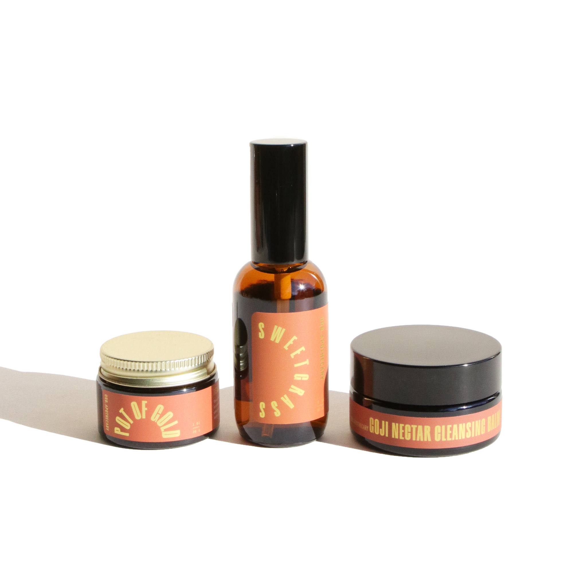 Showcases Urb Apothecary skincare products, including Pot of Gold balm, Sweetgrass spray, and Goji Nectar Cleansing Balm.

