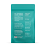 A teal bag showcases Purity Coffee FLOW, detailing its organic arabica coffee ingredients, health benefits, and brewing recommendations for optimum flavor.
