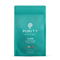 Purity Coffee's teal bag showcases their "Flow" medium roast ground coffee, emphasizing organic and bird-friendly sourcing.
