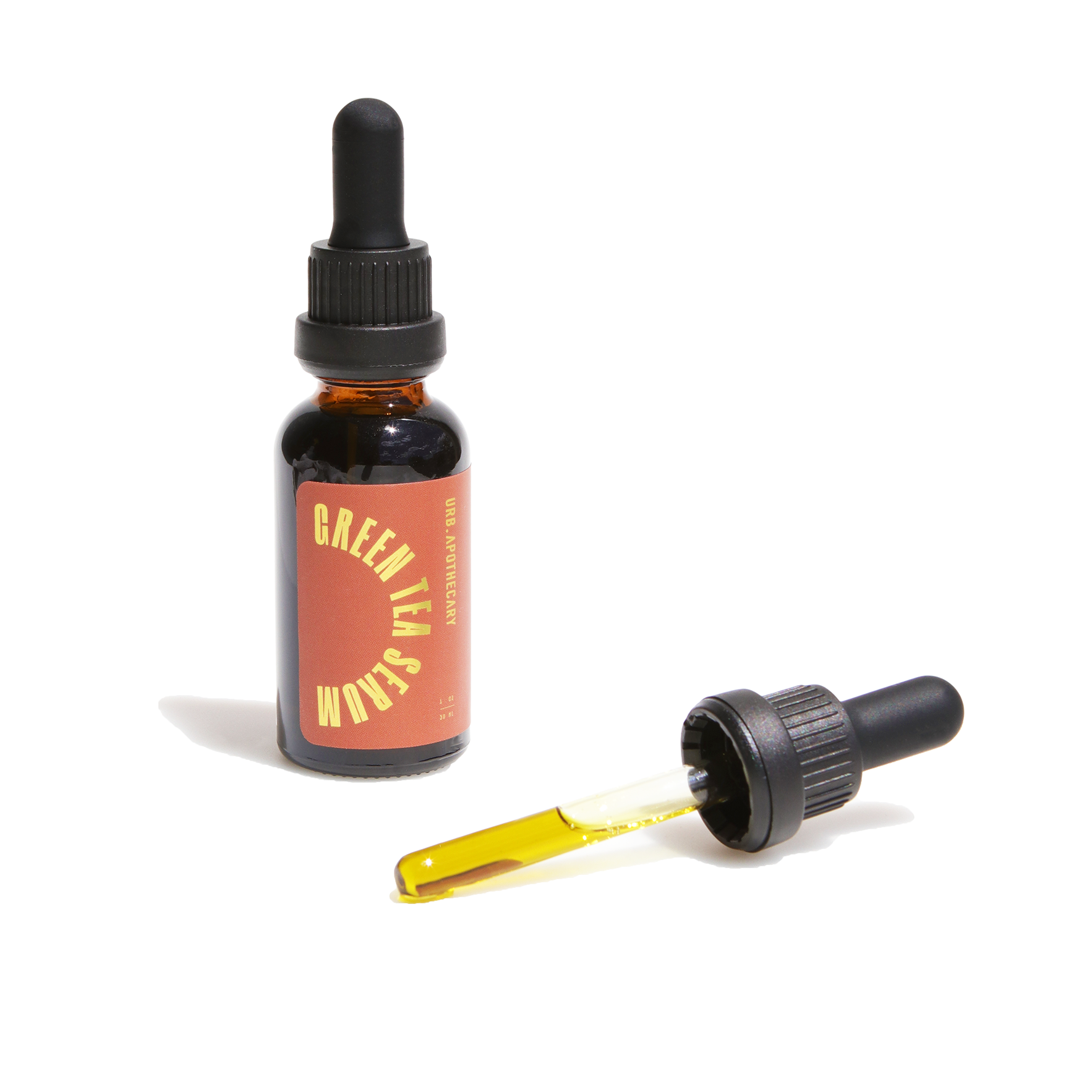 Displaying a bottle of Urb Apothecary Green Tea Serum with its dropper lying separately, revealing a yellow-tinted liquid.
