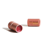 Showcases URB Apothecary's coral-colored, buildable lip and cheek balm in sustainable paper packaging.
