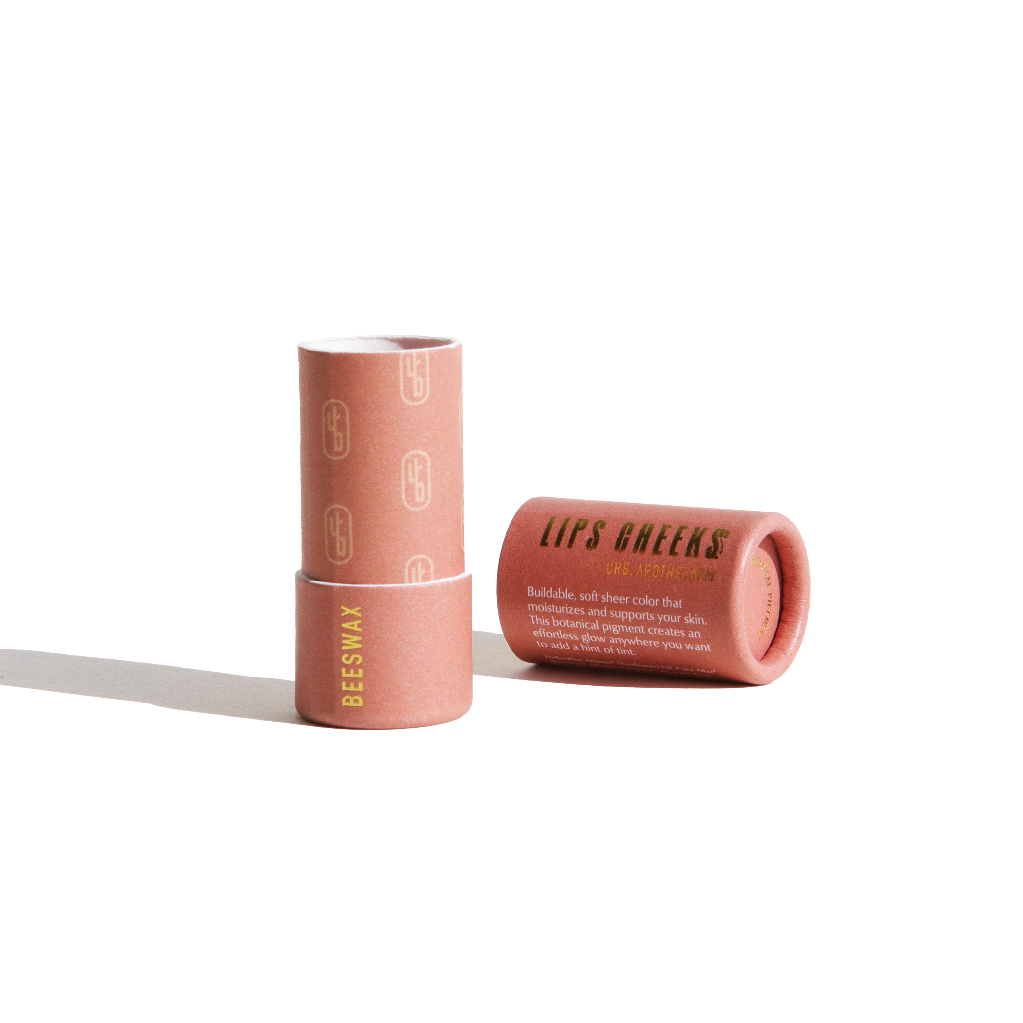 Display shows Urb Apothecary's plastic-free beeswax lip and cheek tint in recyclable paper tube packaging.
