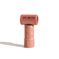 Stack of Urb Apothecary Lips Cheeks beeswax lip and cheek tint sits on a white background.
