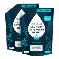 Two dark blue Puracy laundry detergent refill pouches promise 192 loads and a fresh linen scent.

