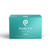A box of Purity Coffee Flow pods displays its branding and promises a smooth coffee experience.
