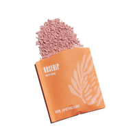 Rosehip bath soak spills from a tangerine packet by Urb.Apothecary.
