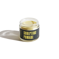 URB Apothecary's Sculpting Pomade promises hair styling with its creamy formula in a clear glass jar.
