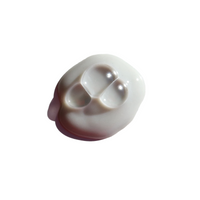 Close-up shows a dollop of white beauty cream containing three clear gel capsules.
