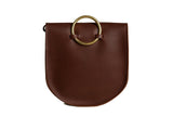 A brown leather handbag features a circular gold handle against a white background.