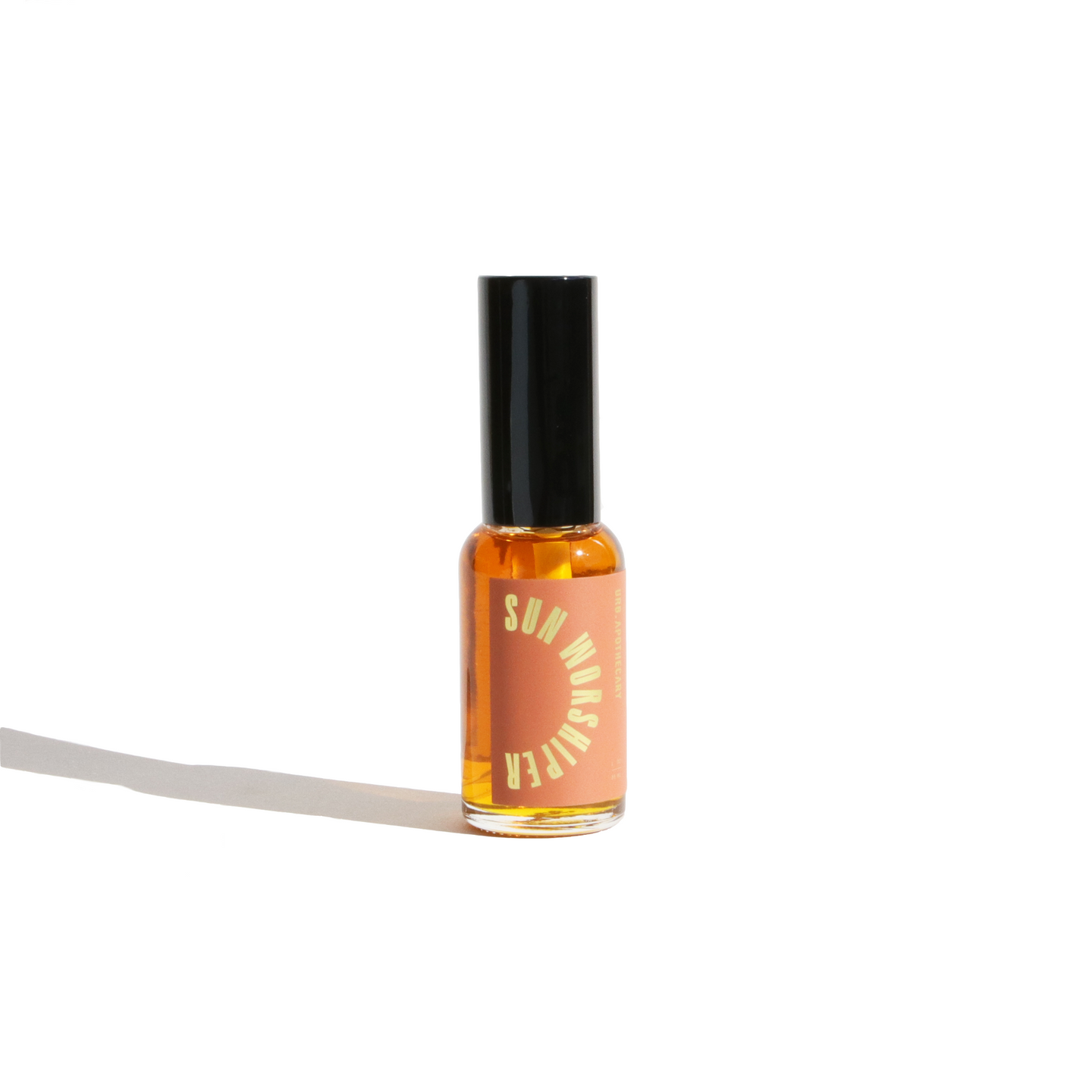 Sun Worshiper roll-on perfume oil sits against a bright white background.
