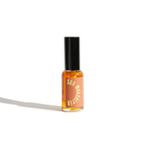 Sun Worshiper roll-on perfume oil sits against a bright white background.
