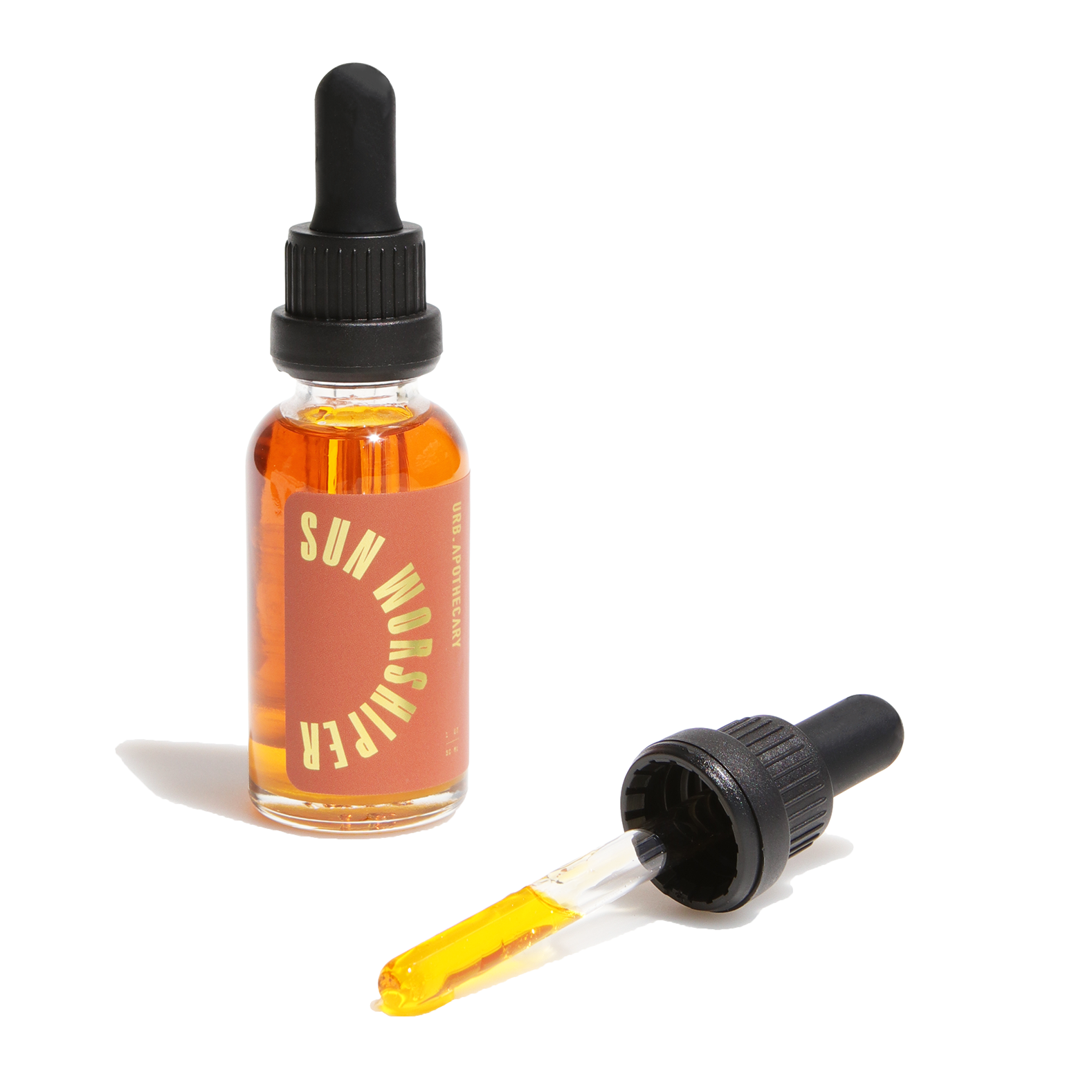 Sun Worshiper face oil sits next to its dropper, showcasing its golden hue and skincare benefits.
