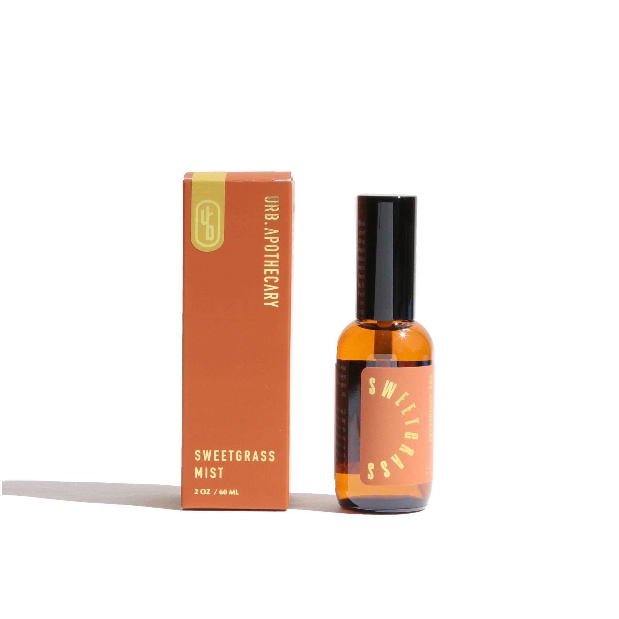 URB Apothecary's Sweetgrass Mist sits beside its orange box on a white background.
