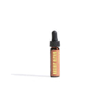 Rosehip repair oil sits upright in a brown bottle with a dropper on a white background.
