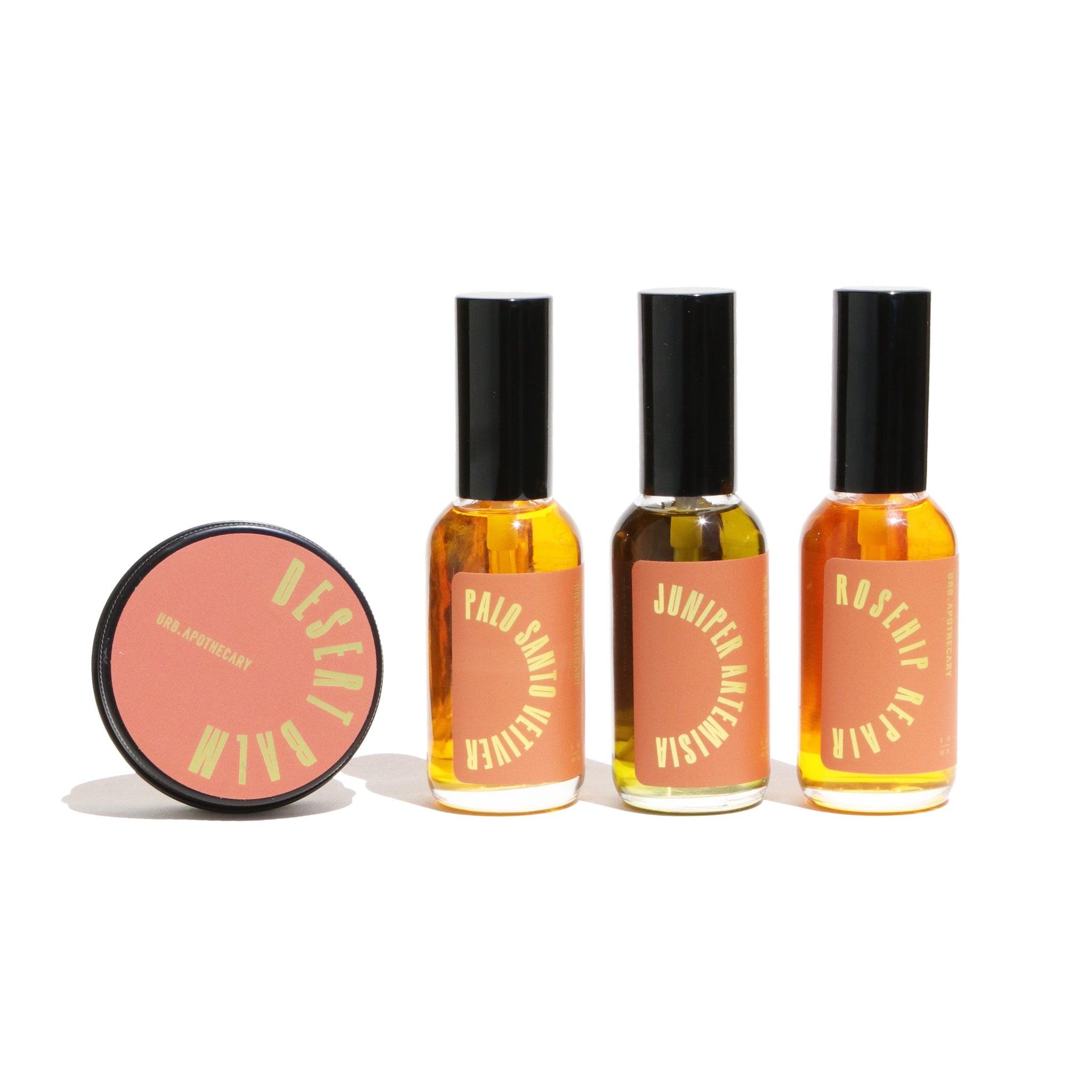 Display features Urb Apothecary's wellness products, including Desert Balm, Palo Santo Vetiver, Juniper Artemisia, and Rosehip Repair essential oil blends.
