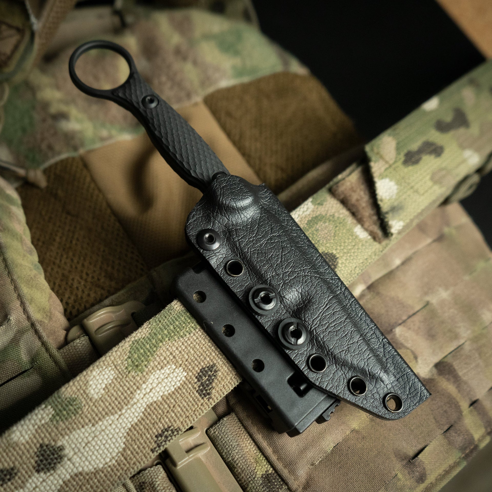 Black belt clip with knife on a camouflage background