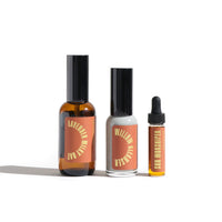 Three bottles of skincare products, including lavender milky oat, willow cleanser, and sun worshiper serums, sit on a white surface.
